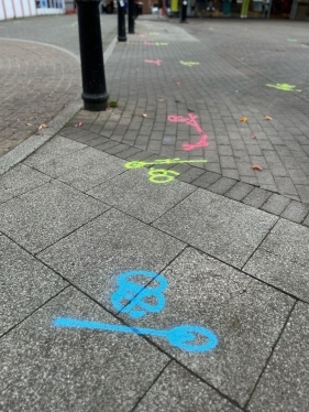 Pink, blue and yellow markings on the ground of St Editha's Square