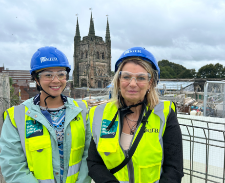 Cllr Nova Arkney (left) and Cllr Carol Dean (right) in high vis jackets and blue helmets on top of a building site