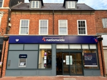 A front view of the new nationwide building. A brick building with the purple nationwide logo across the middle of the building