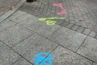 Pink, blue and yellow markings on the ground of St Editha's Square